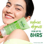 Woman holding a Simple refreshing facial wash tube with text about dryness reduction.